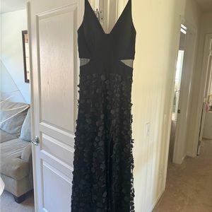 Black evening dress with appliqués.